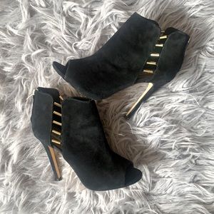 Black heeled booties with gold accent
